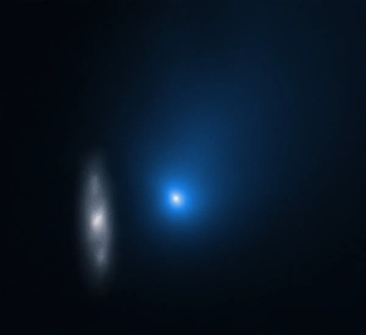 Comet Borisov imaged by Hubble, with a distant galaxy smeared out to its left