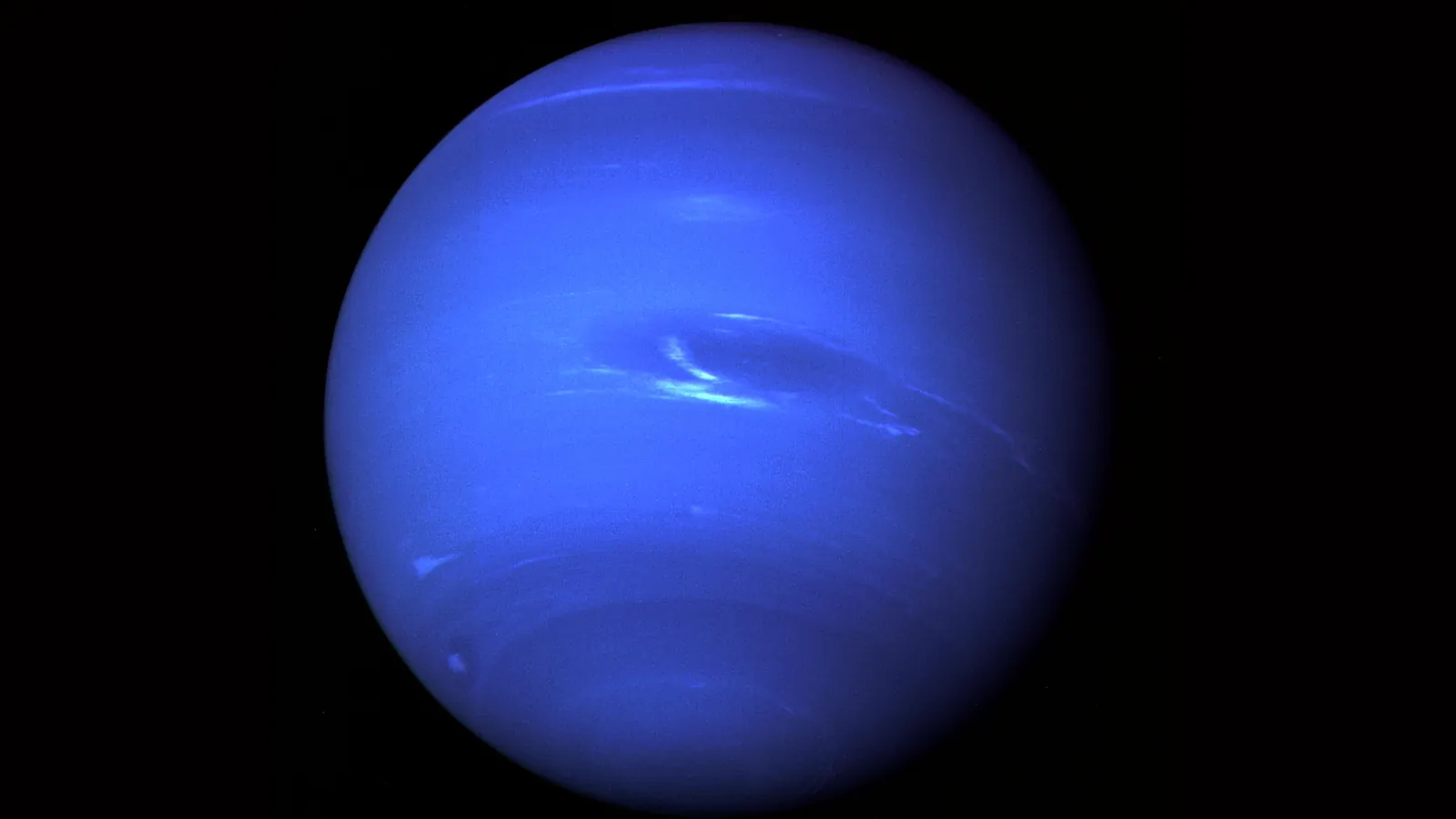 Neptune imaged by Voyager 2, with the Great Dark Spot and a bright white cloud near its center