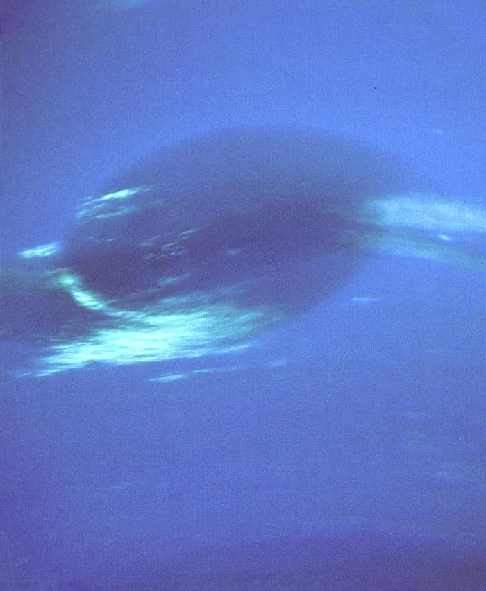 Neptune's Great Dark Spot seen up close by Voyager 2, with white cirrus clouds along its edge